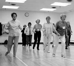 Participants in the Edmonton Lifelong Learning Association Ballroom Line Dance class strut their stuff.