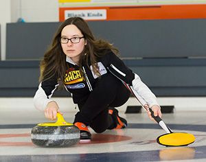 Sarah Brown throwing a stone in a curling rink