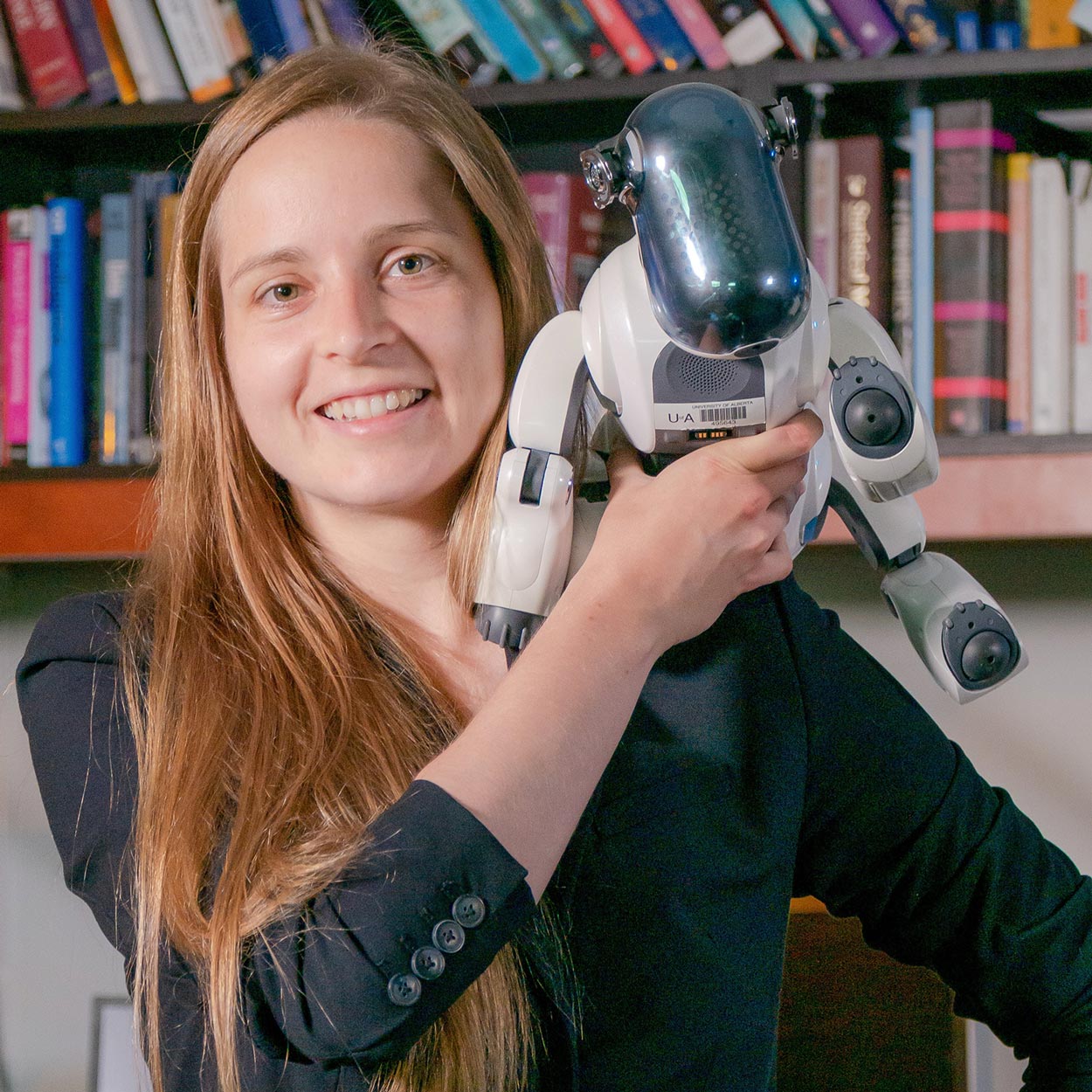 Profile photo of Martha White with a robot on her shoulder.