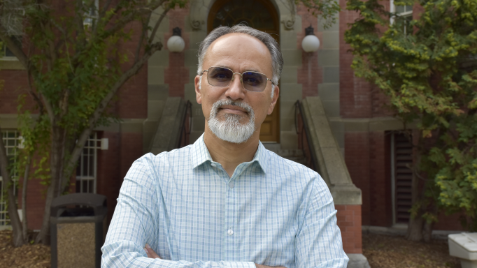 Hassan Masoud standing in front of the Arts building.