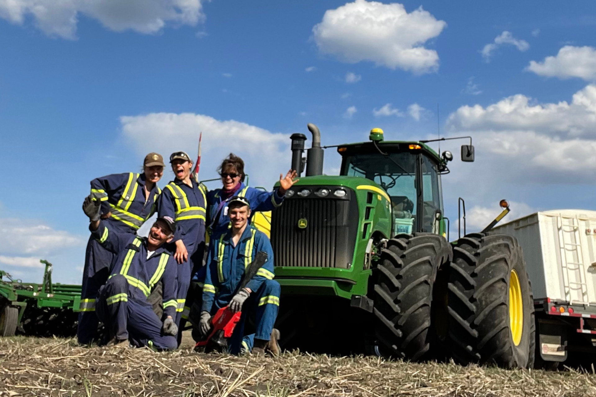 The Katernchuk family in front of an Air Seeder during spring seeding.