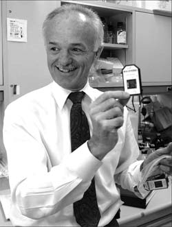 Dr. Phil Halloran holds a gene chip, a handheld device that records genes in tissue samples, and can predict organ rejection in transplant patients. The first project of The Alberta Transplant Institute Applied Genomics Centre will involve further development of the chip.