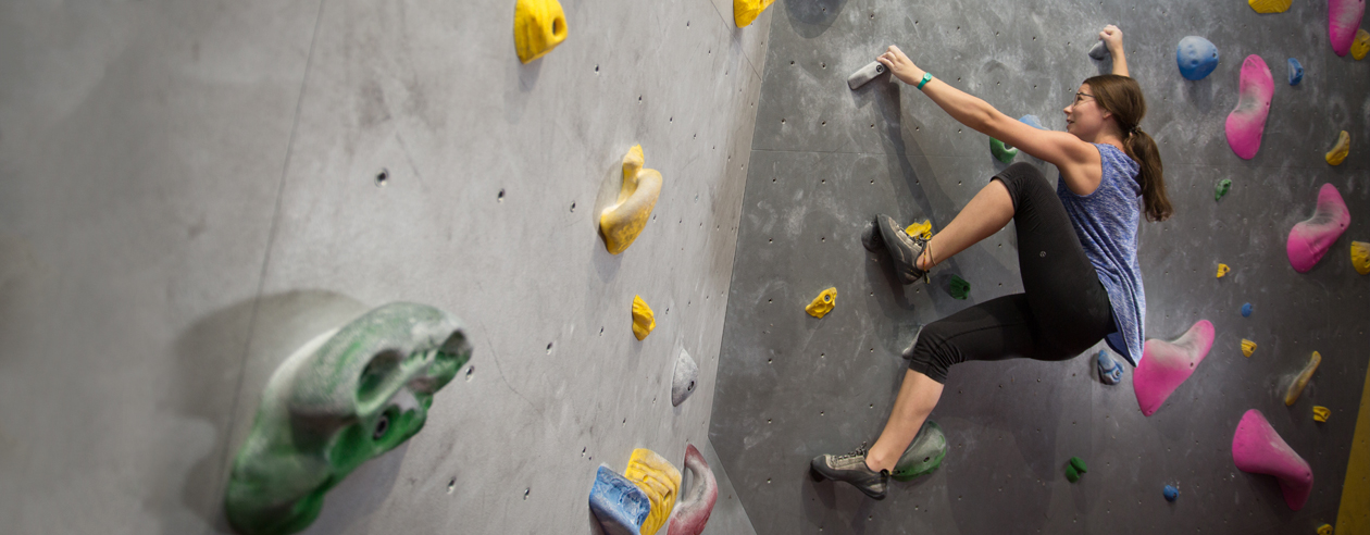 Woman climbing the wall in Wilson climbing Centre