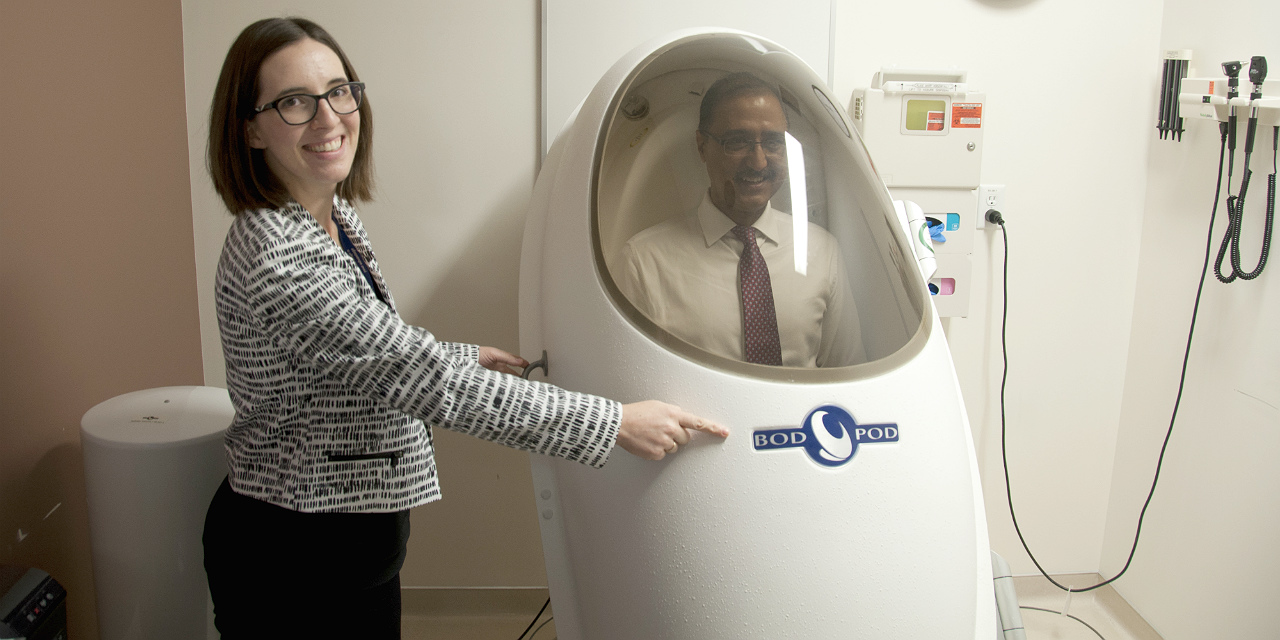 Human nutrition research co-ordinator Stephanie Ramage seals Minister Amarjeet Sohi in the university's body composition tracking system as part of a tour of the Alberta Diabetes Institute, which figured prominently in a federal government funding announcement Jan. 25.