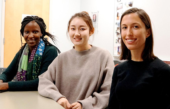  Graduate students sitting at a table from left, Irene Onyango, Yu Feng and Claire Doll from the Department of Resource Economics and Environmental Sociology in the UAlberta Faculty of ALES.