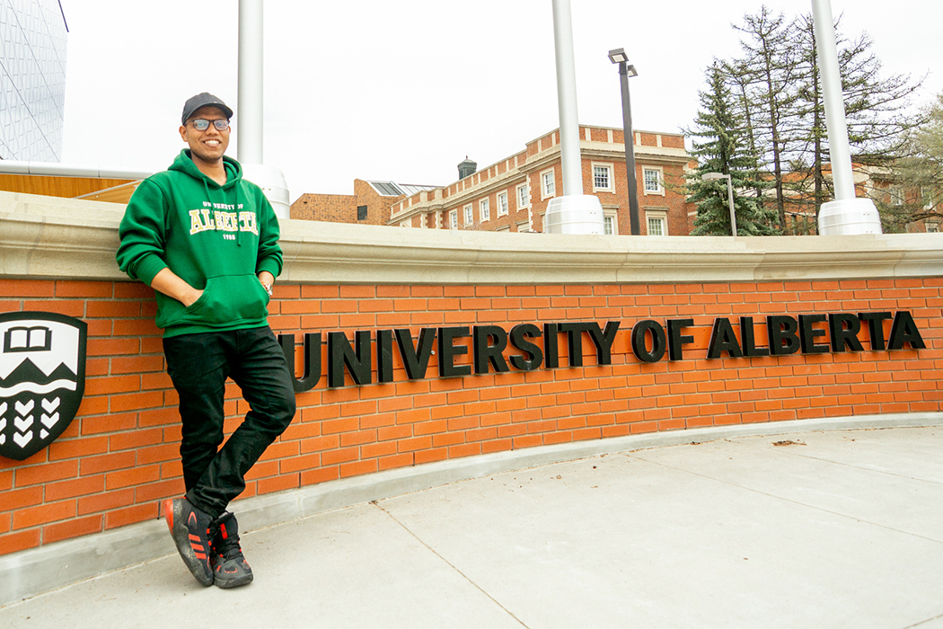 Saiful poses at the University of Alberta sign outside