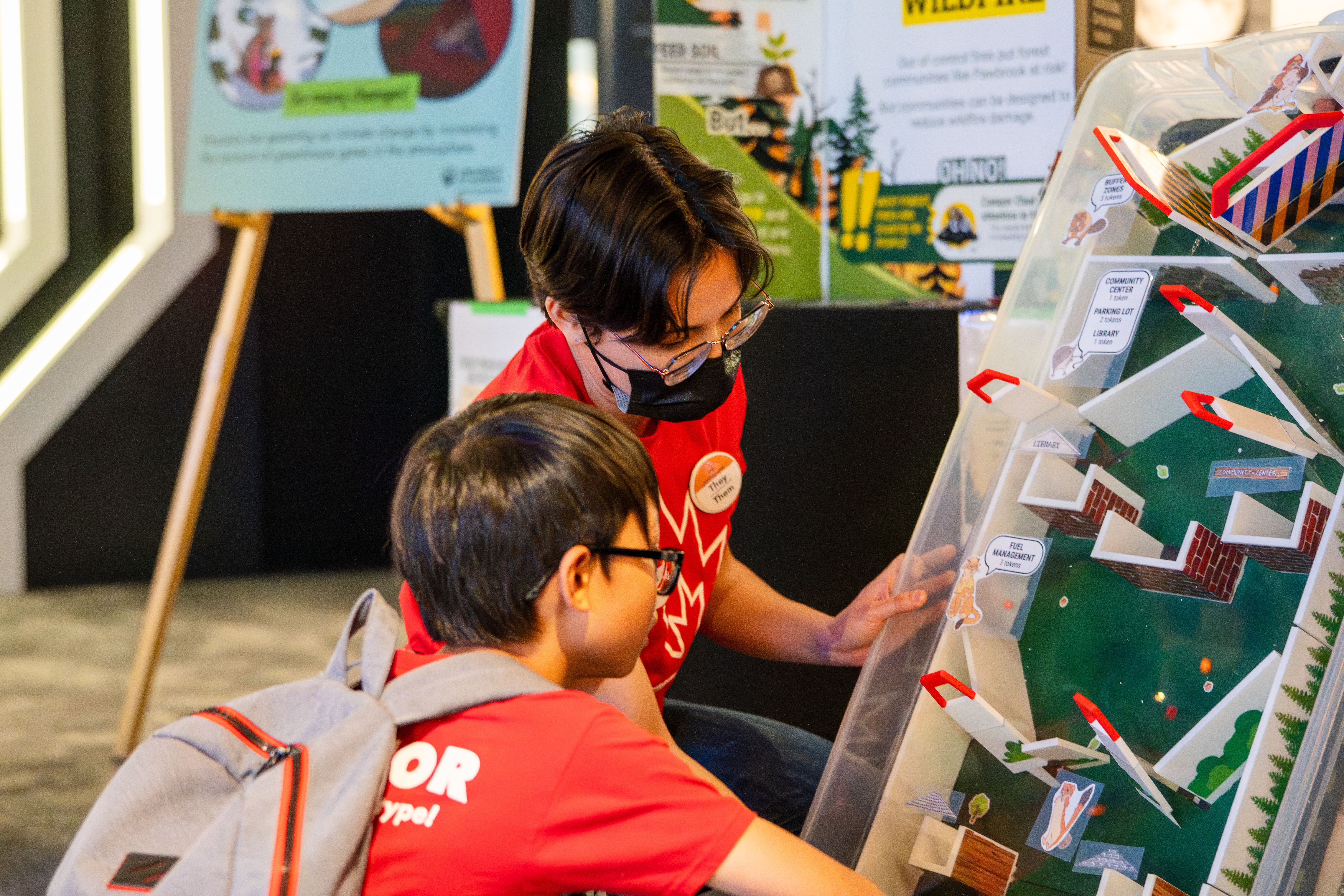 Communications officer, Aysha Wu, helping an attendee with the demo