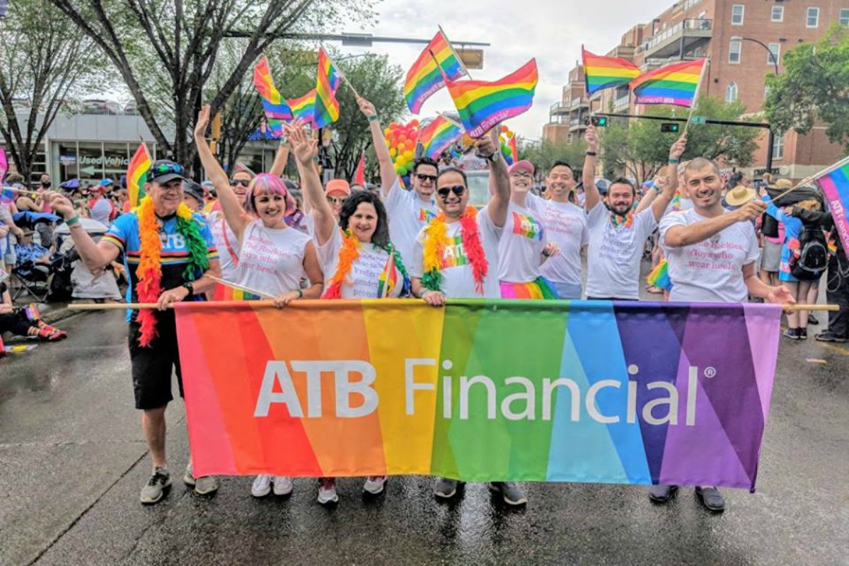 ATB flag in front of celebrating parade goers at Pride