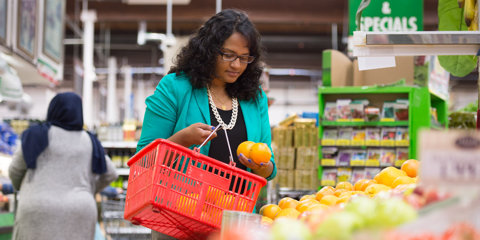 Juanita Gnanapragasam, BSc '16, checks out some fresh produce at the supermarket.