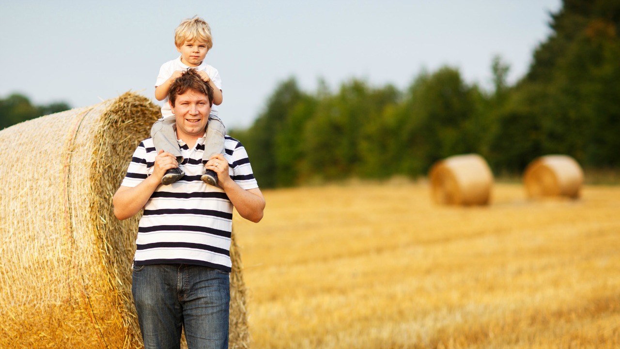 A man and child on a family farm in Alberta