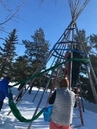 Person taking photo of the tipi frame