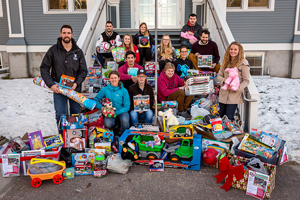 Students stand with the toys they collected during the 2016 Vikes for Tykes toy drive on the steps of Founders' Hall.