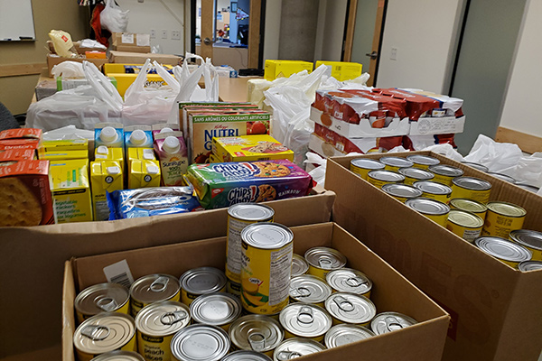 A photo of various non-perishable goods  being packed in boxes in the ASA Office.