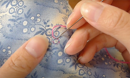 An image of Dr. Sabrina Mark demonstrating embroidery as part of a Crafting Communities session. 