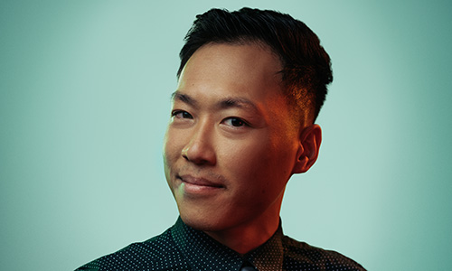 A photo of Tony Nguyen wearing a suit in front of a blue background.