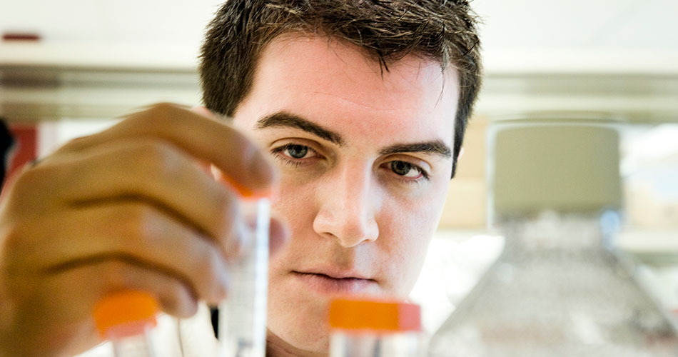 A photo of a chemistry student working with test tubes
