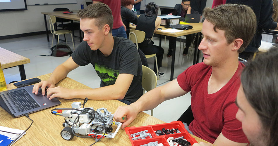 A photo of a students programming in a robotics class