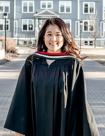 A photo of Hyun-Joo Lim in front of Founders' Hall