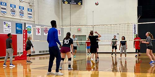 A photo of students playing intramural volleyball