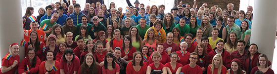 A group of students and staff posing in rainbow coloured shirts for Pride Week