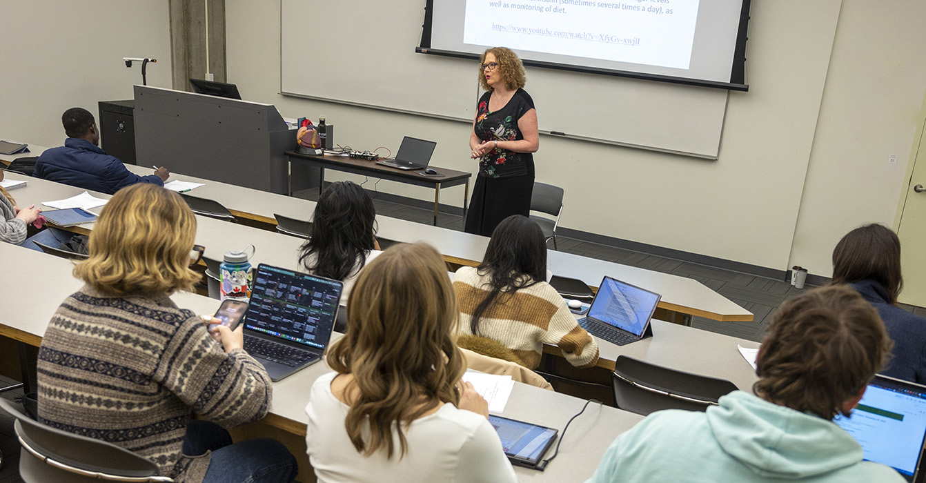 Professor teaches a class of masters students.