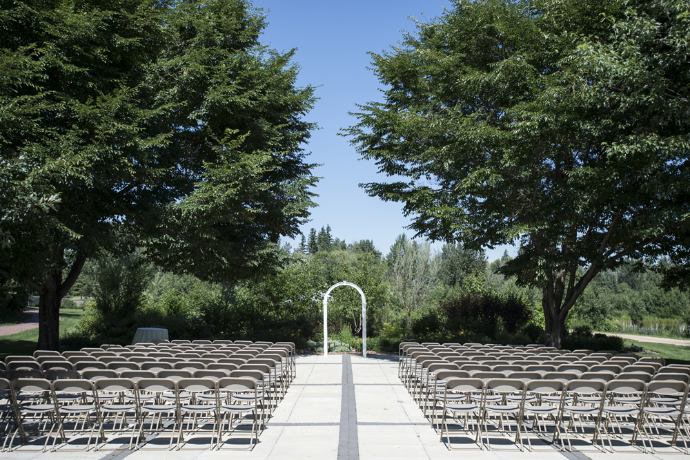 Wedding ceremony setup with an archway and rows of chairs