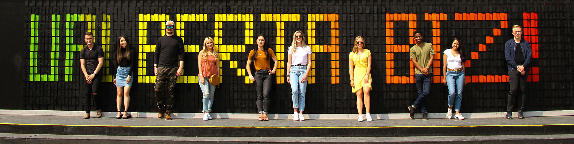 Business Students in front of Happy Wall
