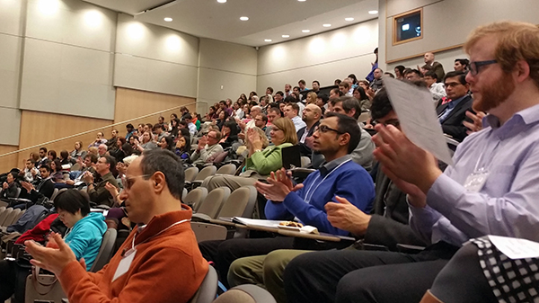 CRINA Research Day attendees applaud a presentation.