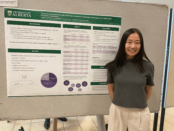 Crystal Liu standing by her poster board