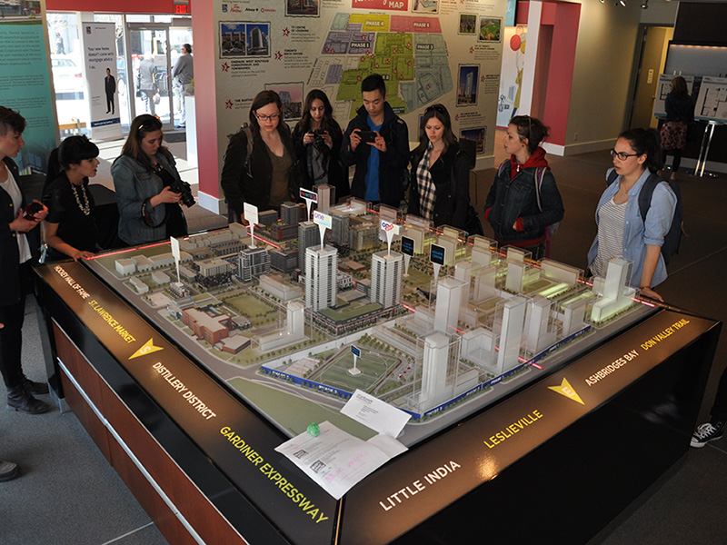 Field School students examining a scale model of a city development plan in Toronto.