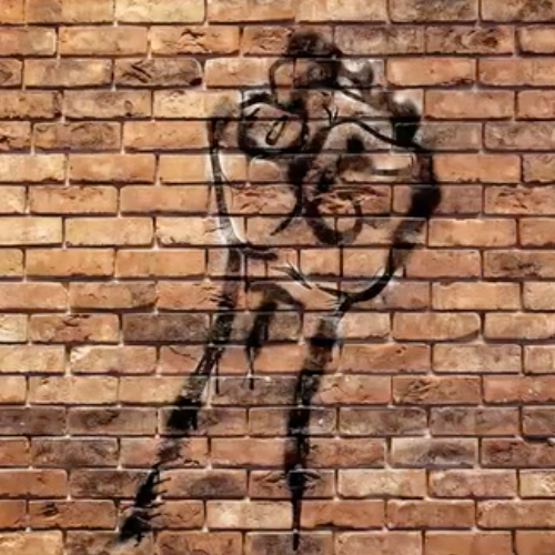 fist painted on brick wall