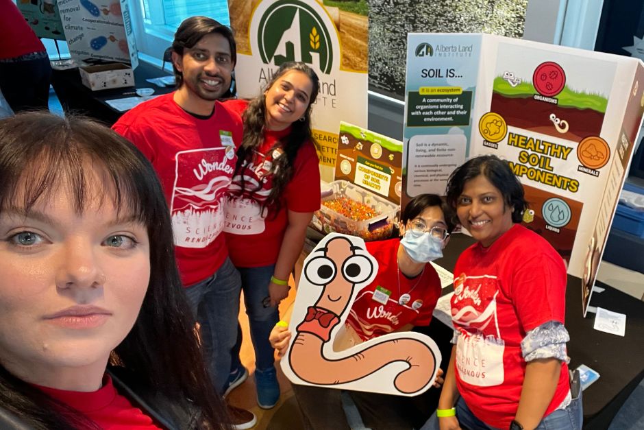 ALI staff and volunteers pose at booth
