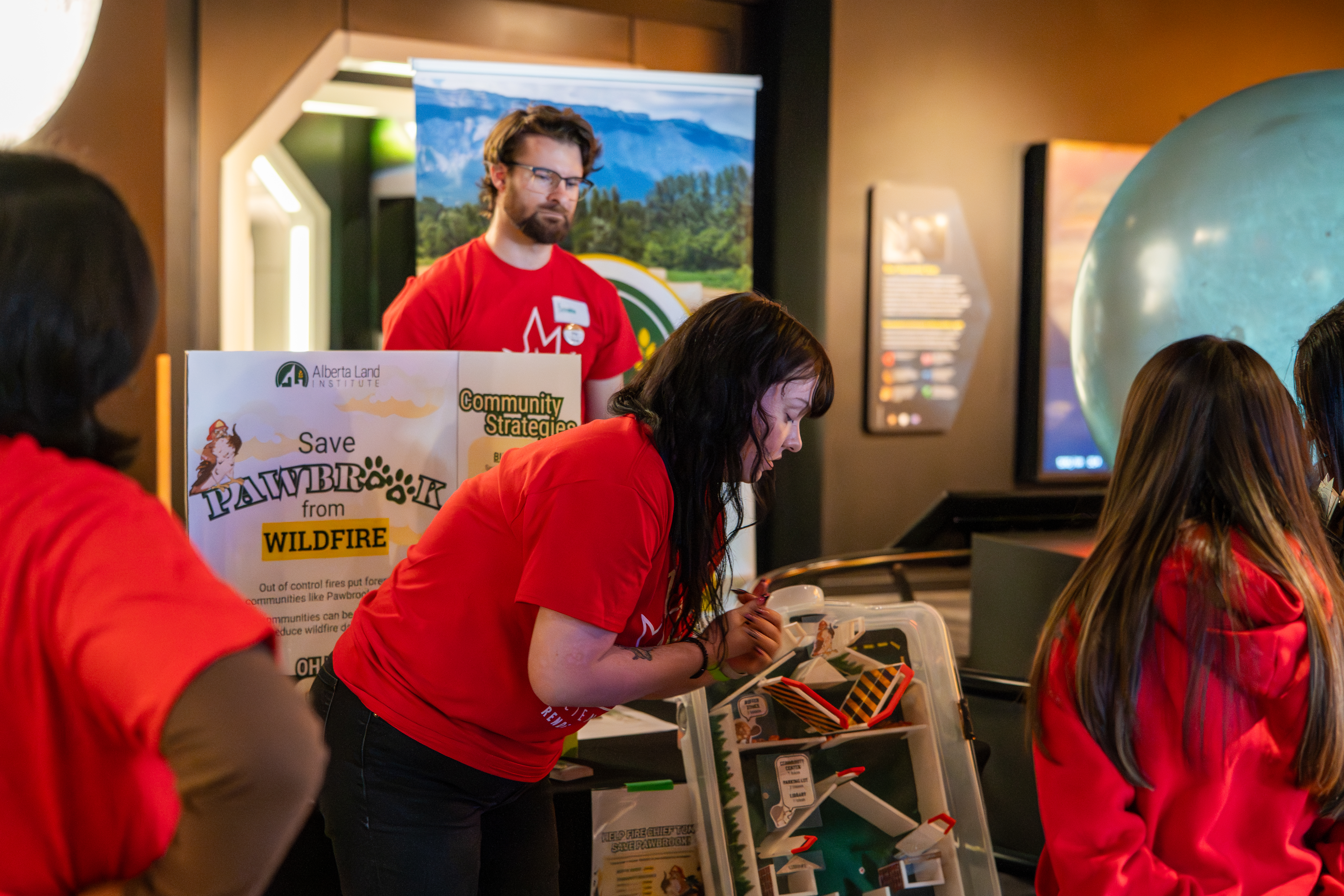 Institute coordinator, Kate Forer, and volunteer, Brandon Dyck, explaining the demo to attendees