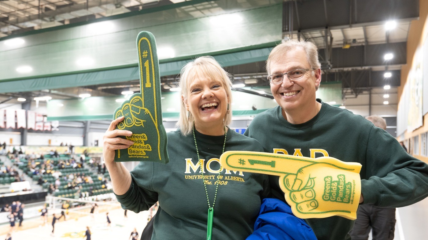 Two parents at a basketball game