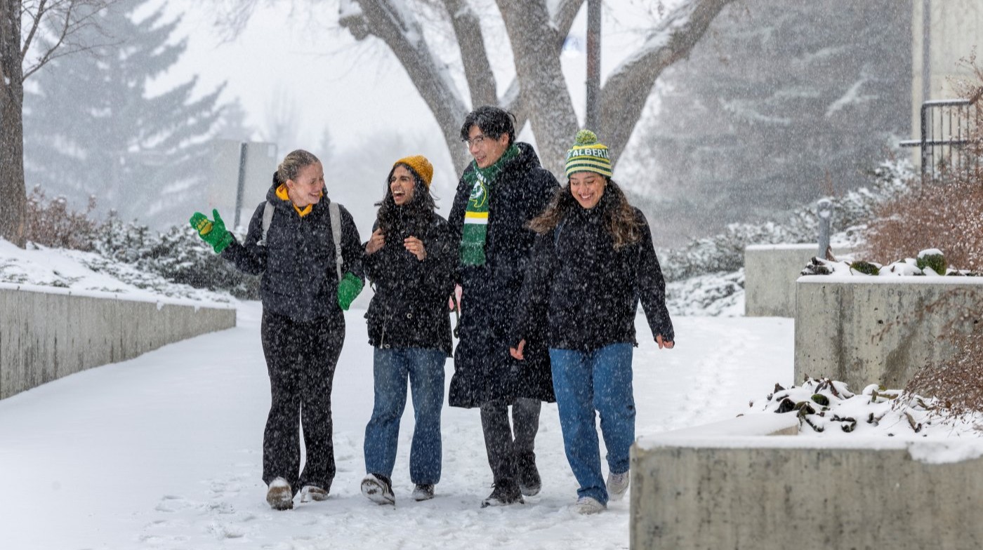 Three students wearing U of A winter gear