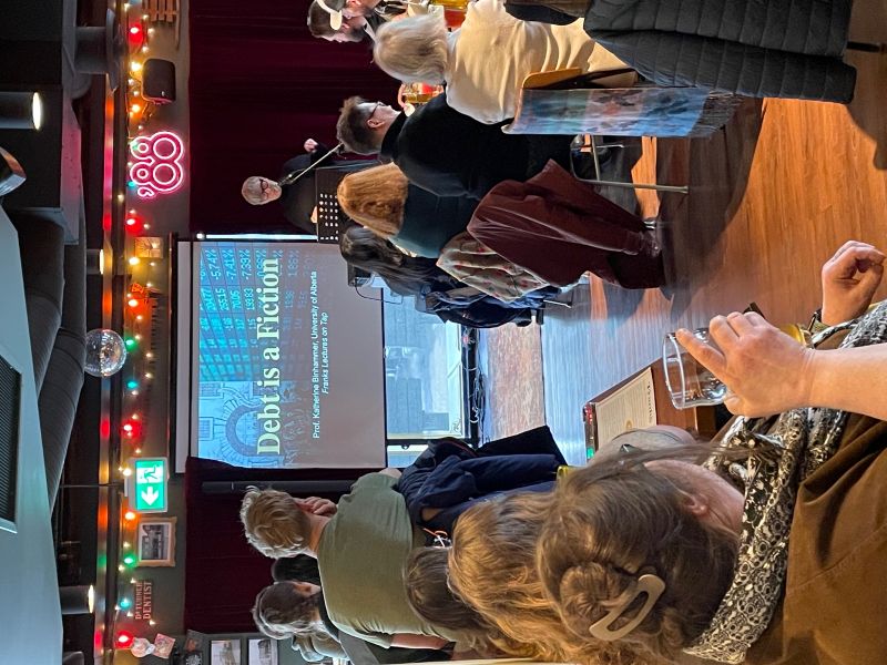 Katherine Binhammer speaking to a group of onlookers at Frank's Pub