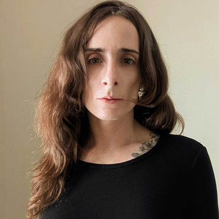 An image of Dr. Blair Attard-Frost, a woman in a black sweater looking directly at the camera.
