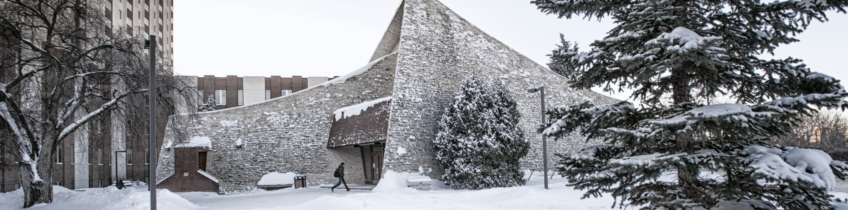 Tory Lecture Theatre in Winter with student walking