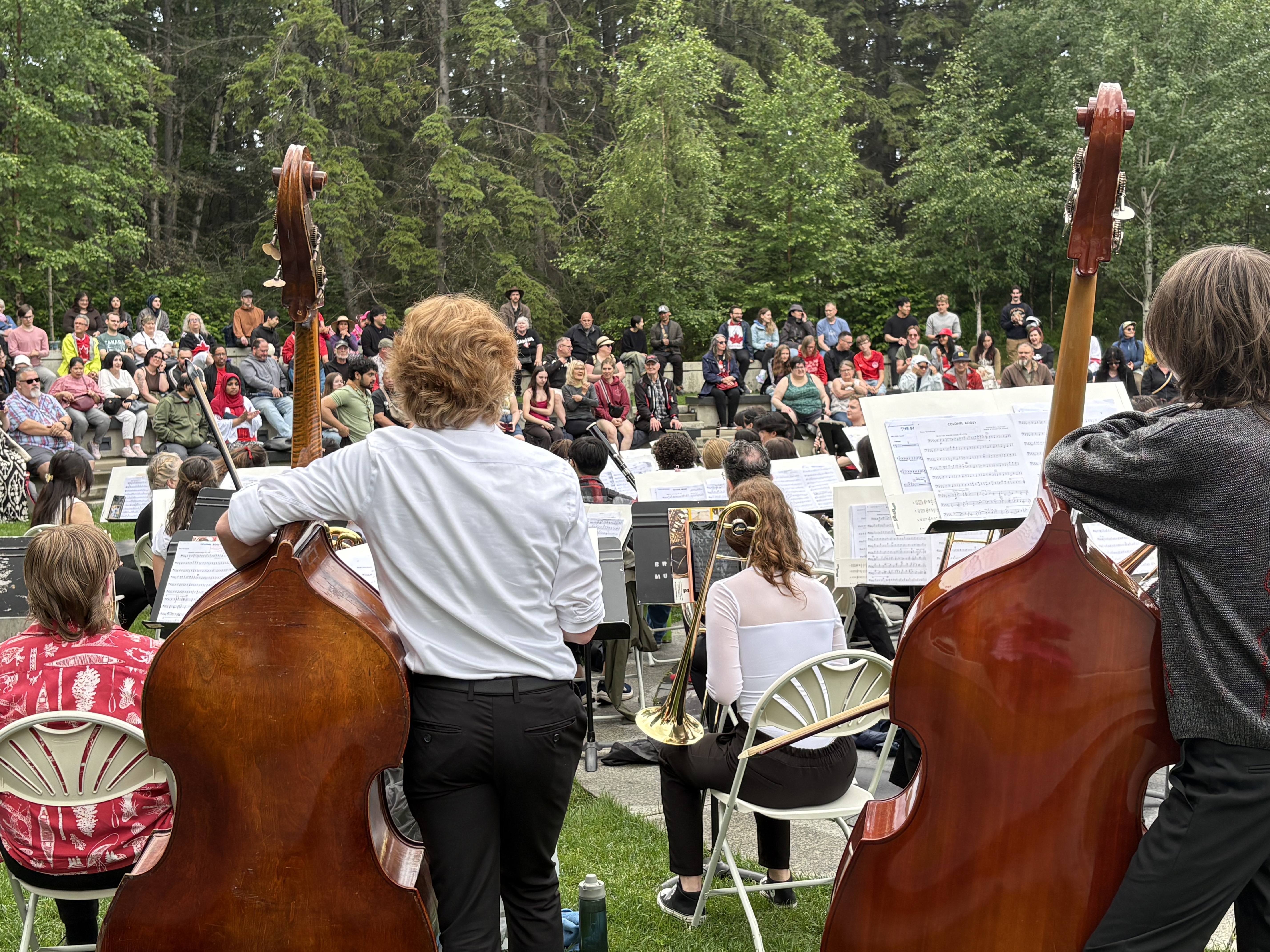 cello player facing audience in amphitheatre