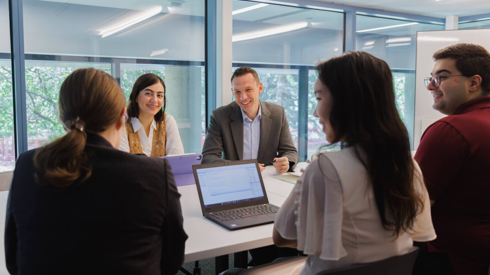 Group of people around a table talking