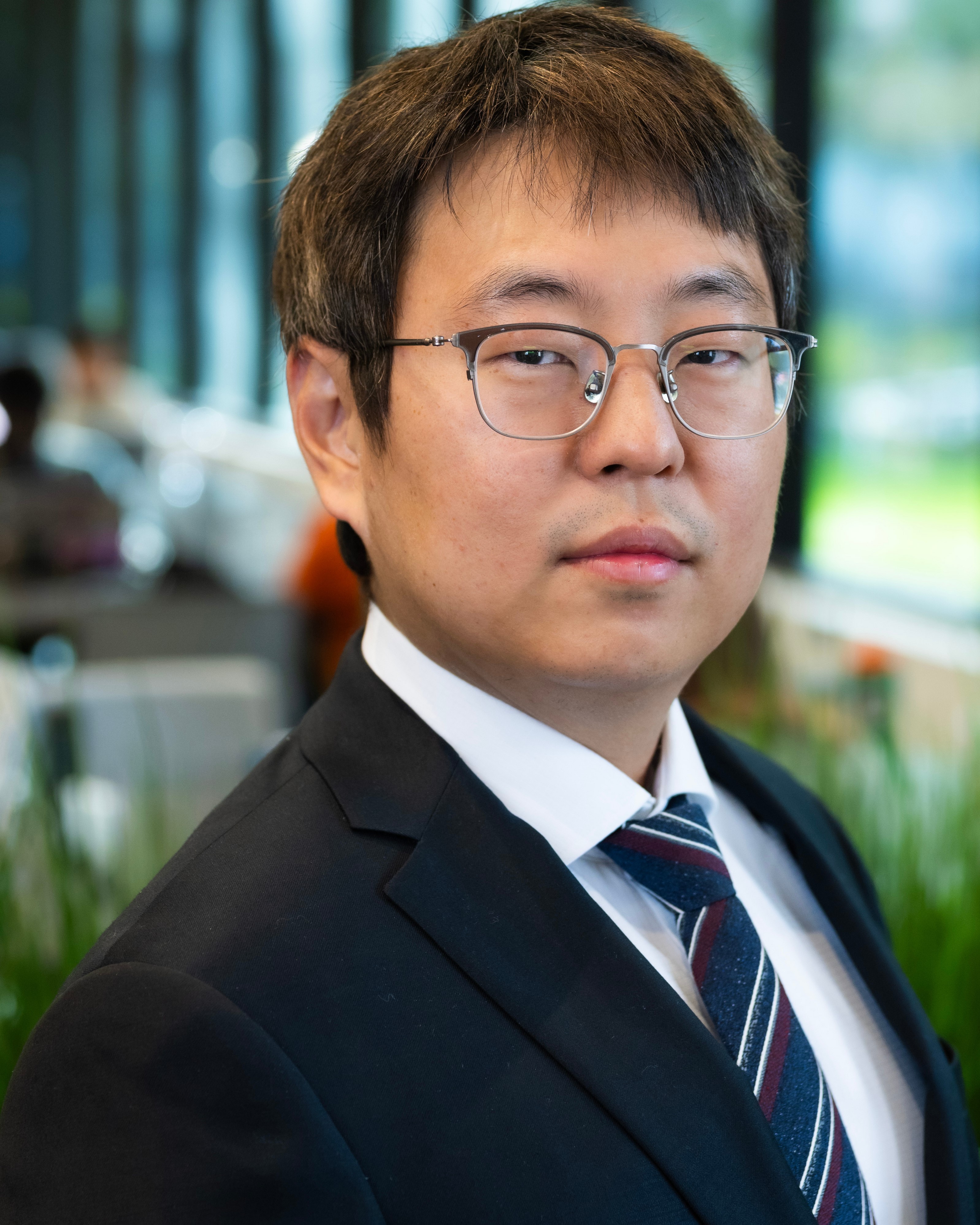 proffesional headshot of Jay Hyun wearing a suit 
