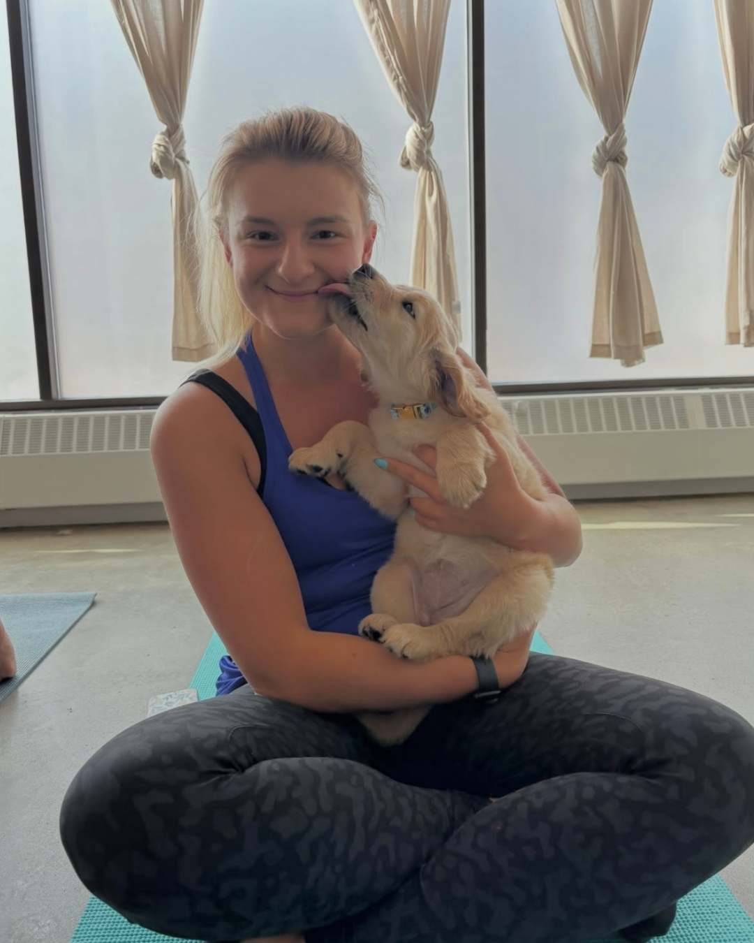 Jacquelyn Zimmerman holds a light coloured puppy