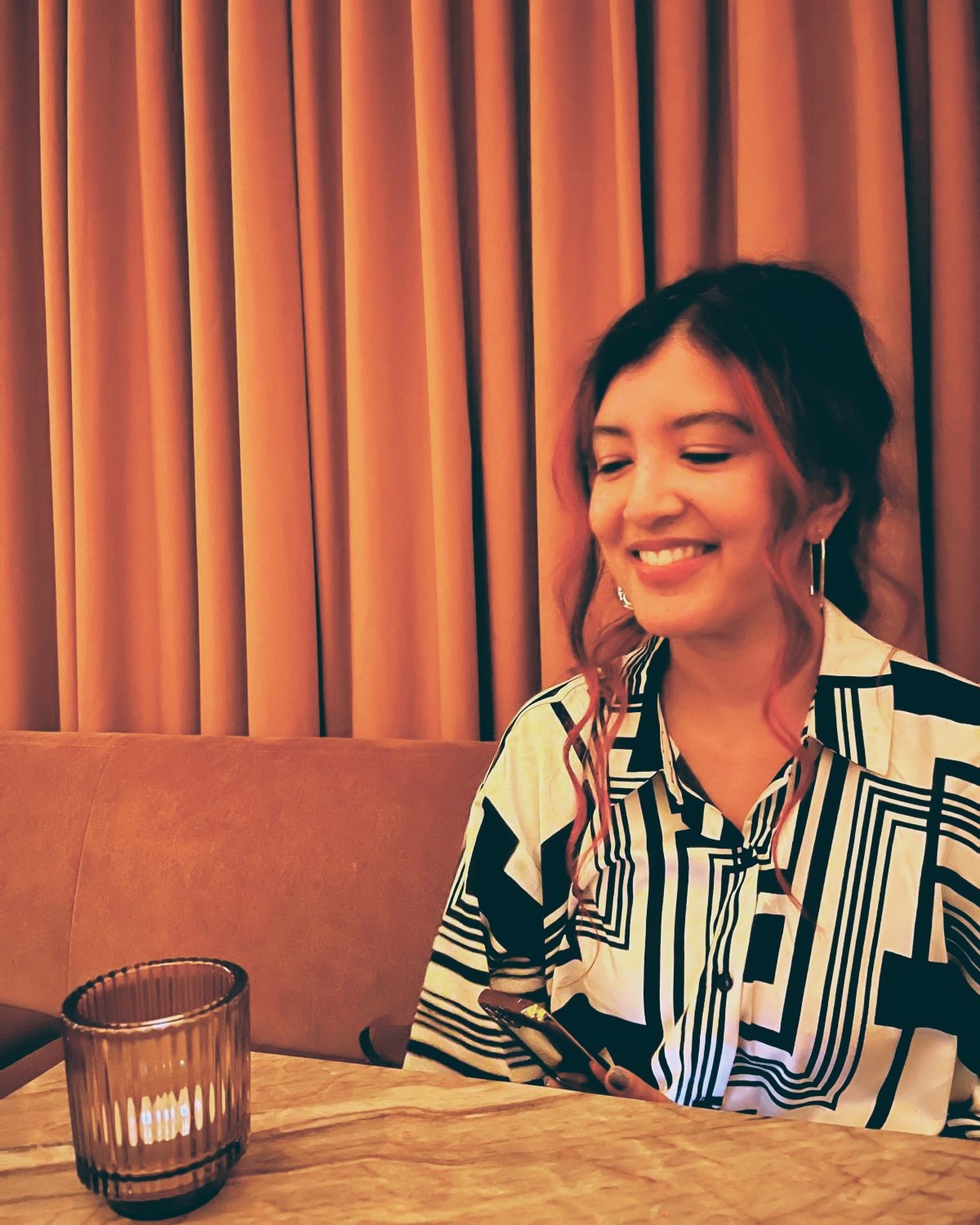 casual image of Monisha smiling at the camera
