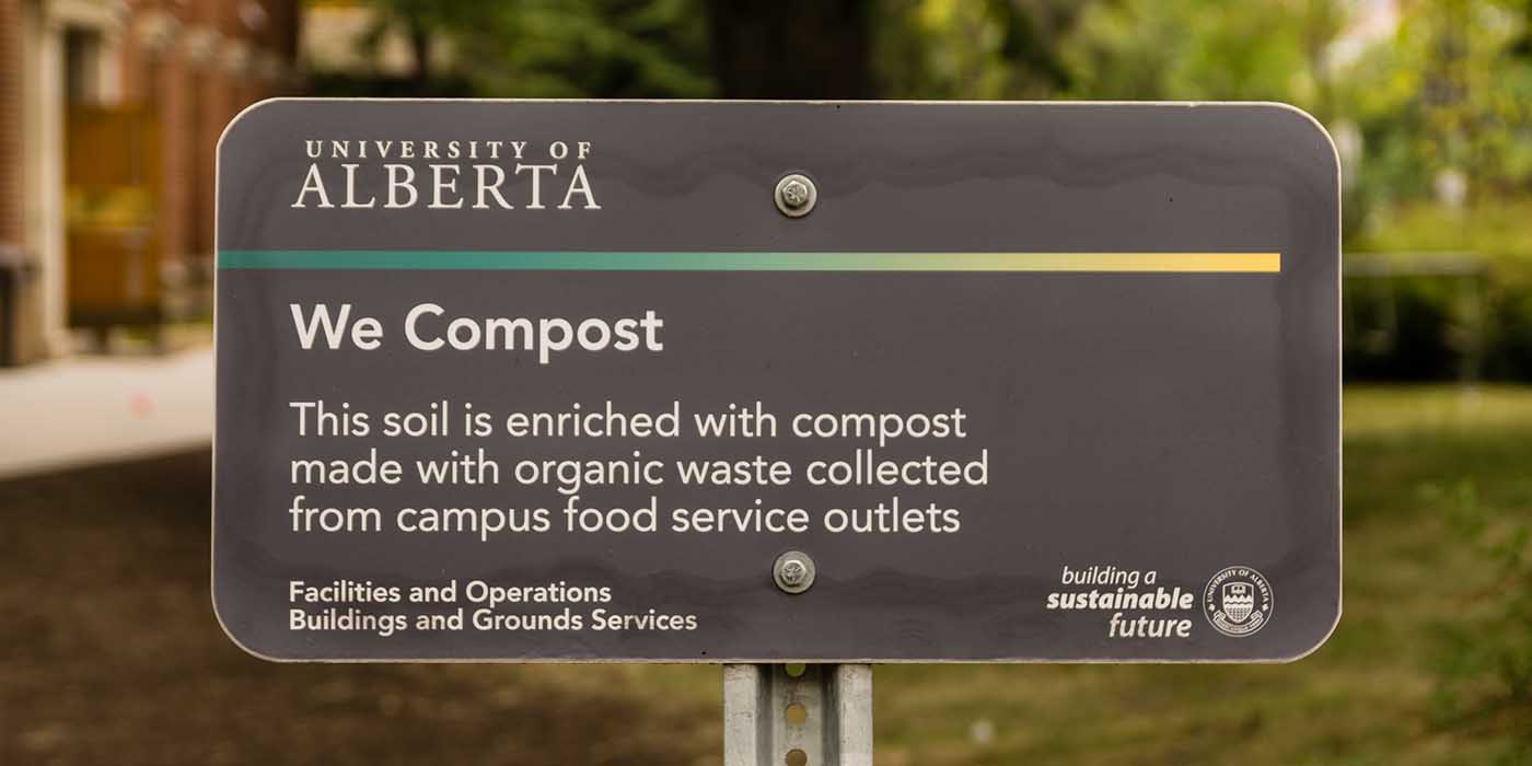 A sign that reads "We Compost"