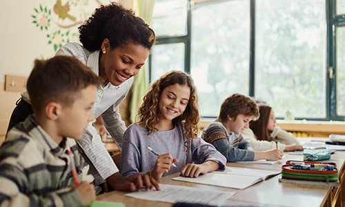 Teacher working with students in science class