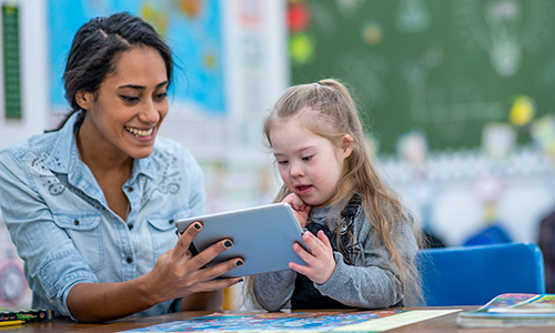 Teacher working with students using a tablet
