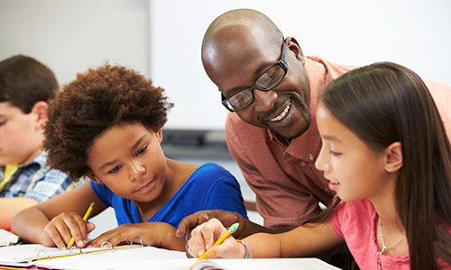 Teacher working with students in science class