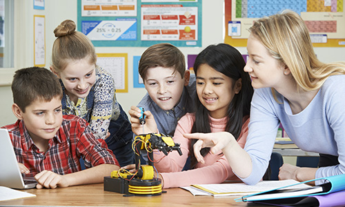 Teacher working with students in science class