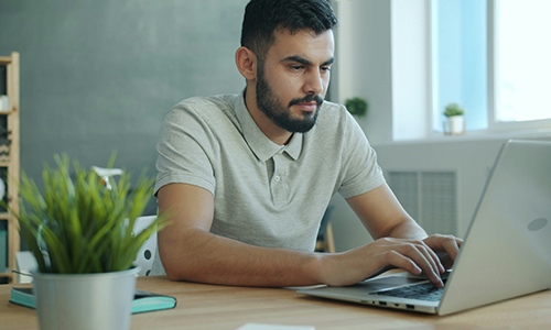 Teacher using computer to take online courses