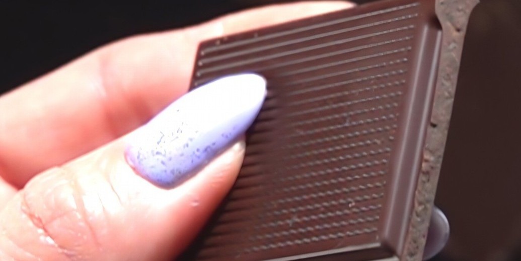 Woman holding a piece of chocolate